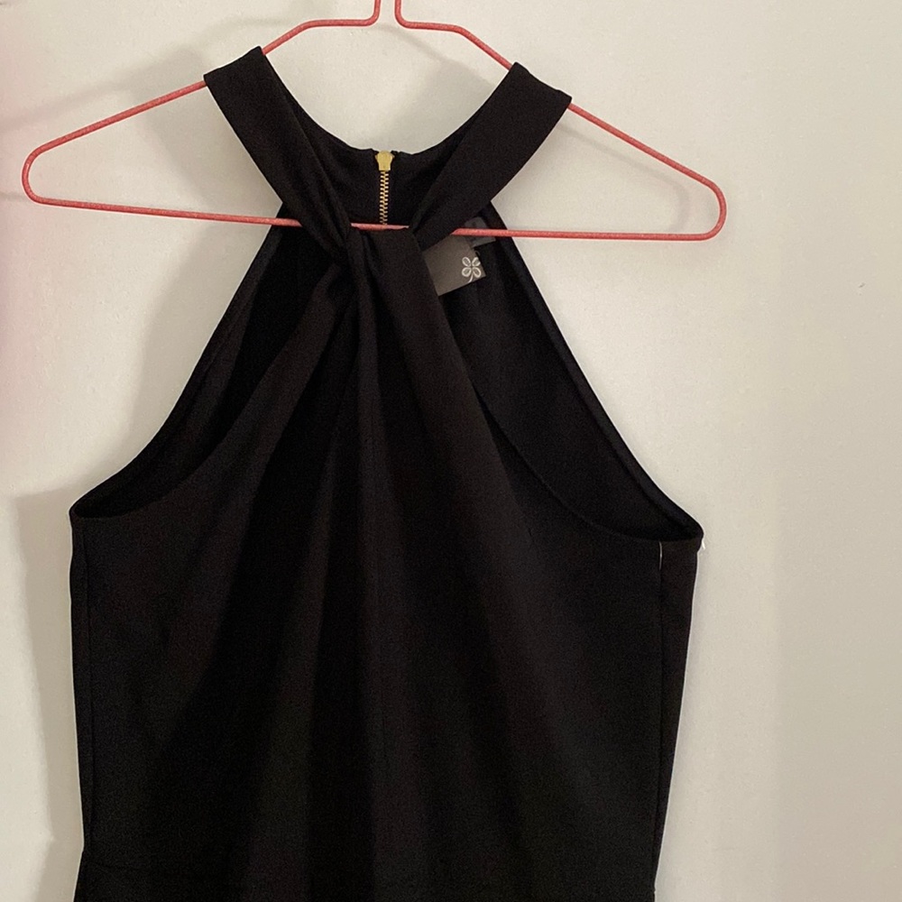 It’s a classy black high neck dress with a gold zipper in the back.